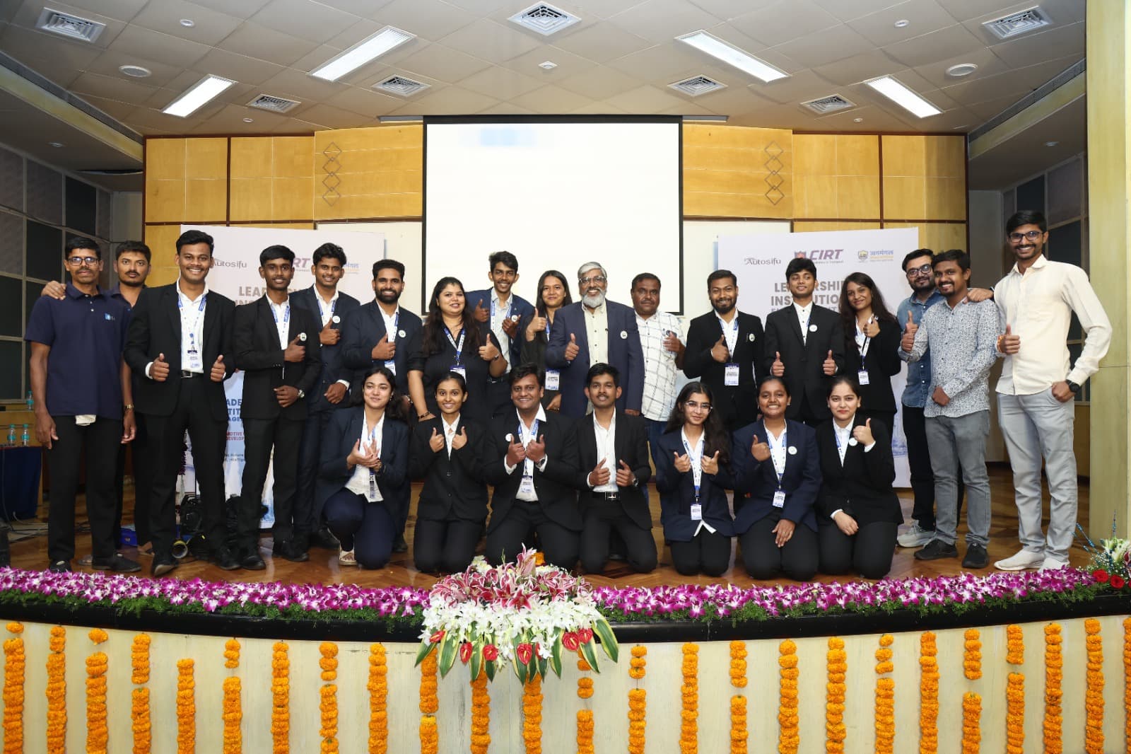 Delegates and students on stage at the Automotive Cybersecurity Principals Meet at CIRT Pune, in front of CIRT, AutoSifu and JagMangal Social Foundation banners.